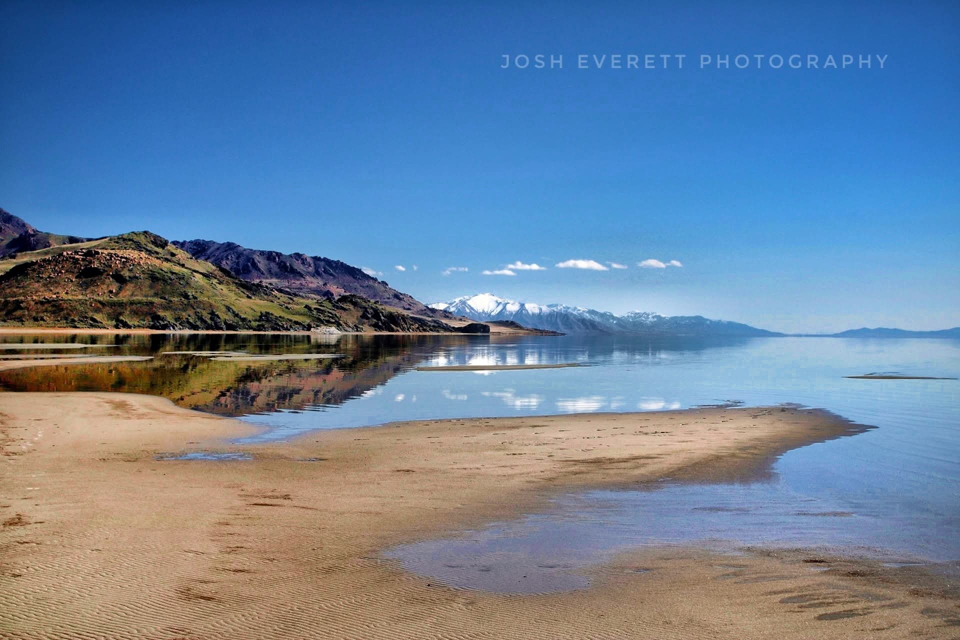 Reflection of the mountains in the water that looks like glass.