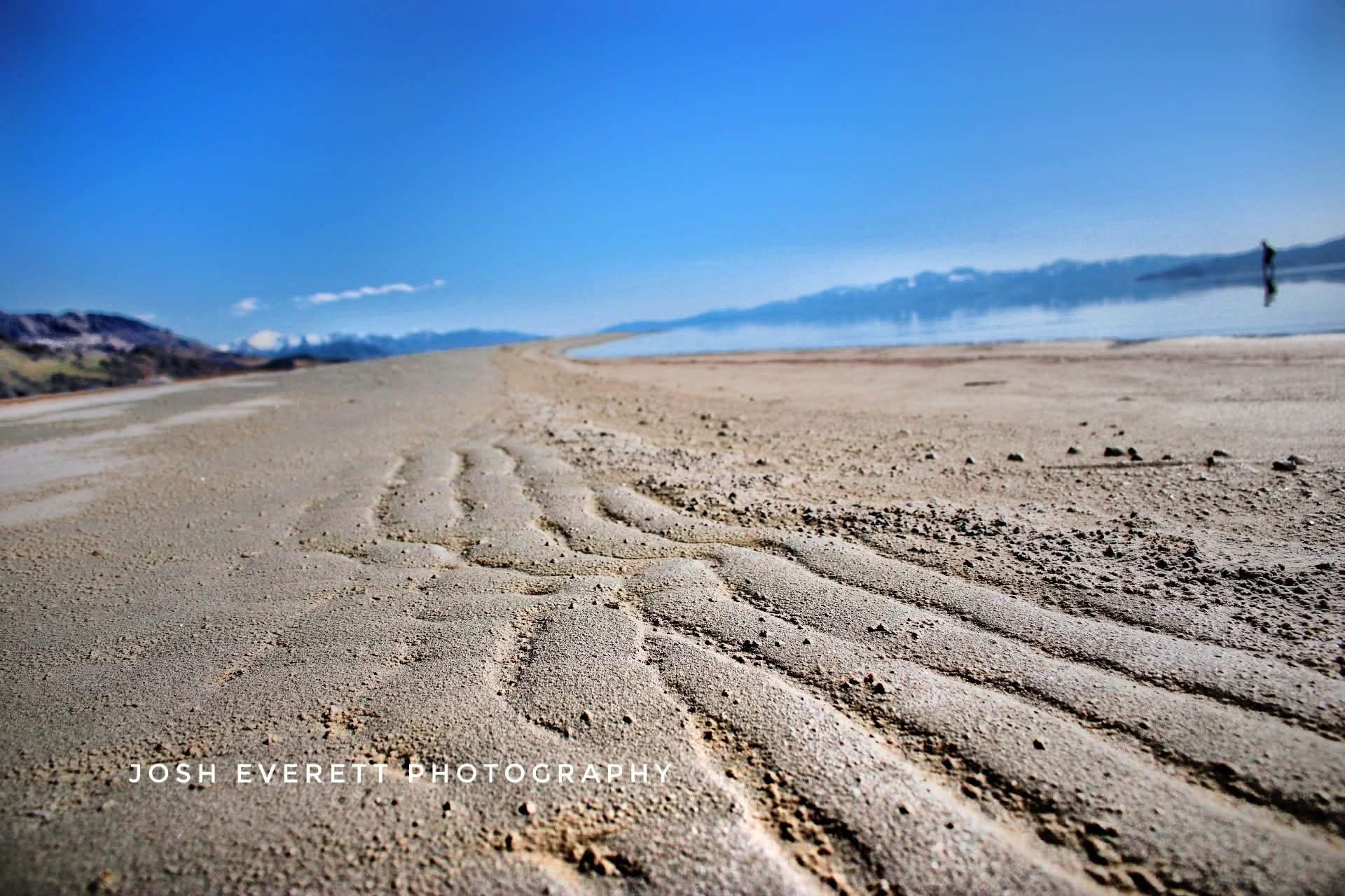 sand that looks like waves while the lake is calm.